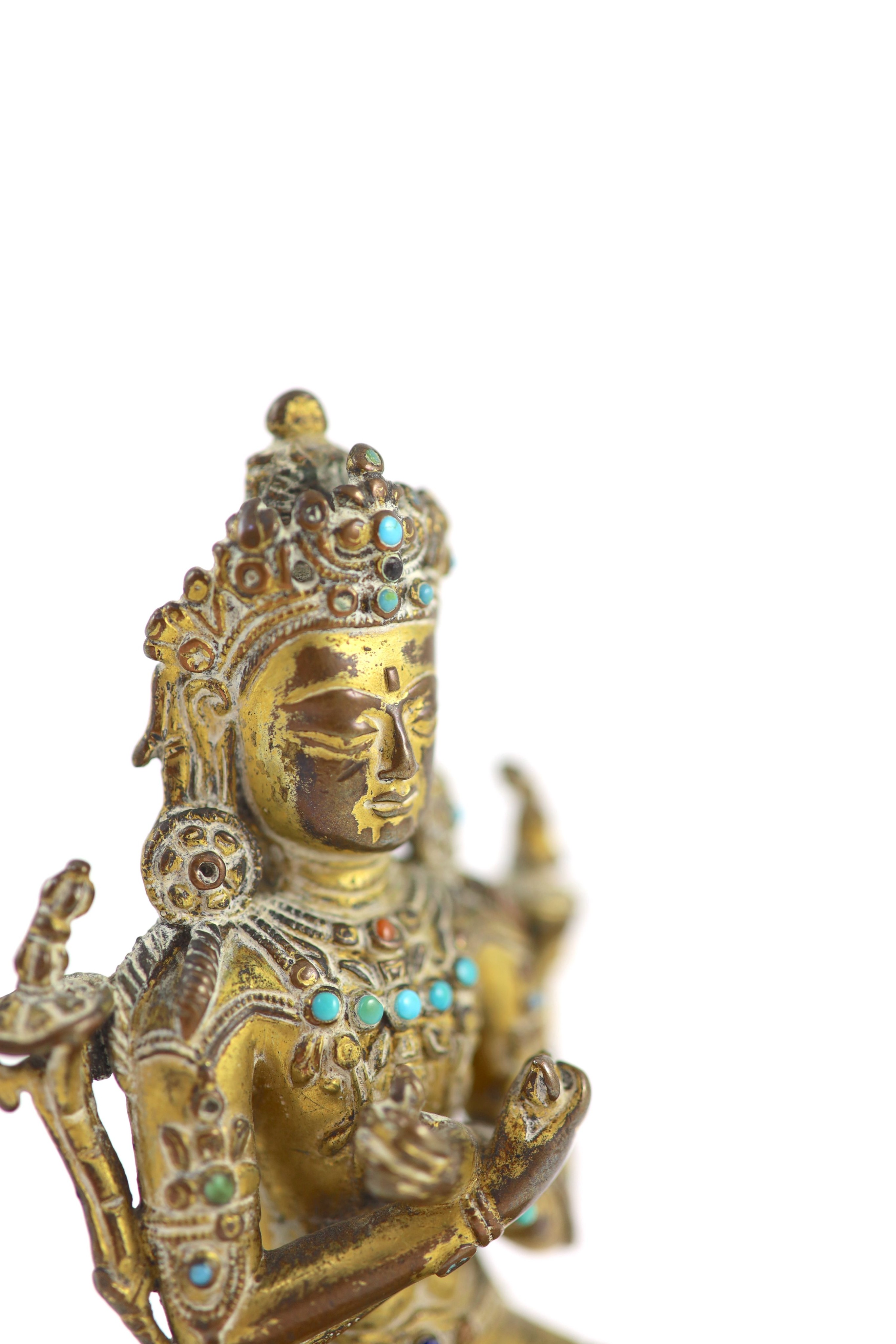 A Tibetan gilt copper alloy seated figure of Maitreya, possibly 15th century, 11.5 cm high